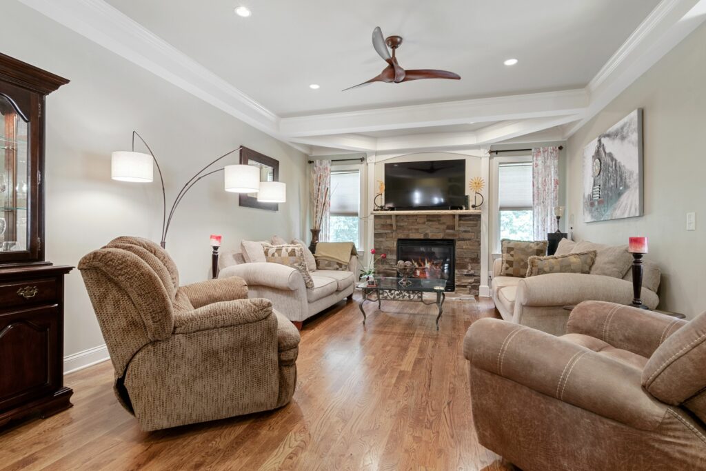 Spacious and elegant living room featuring contemporary furniture and a fireplace.